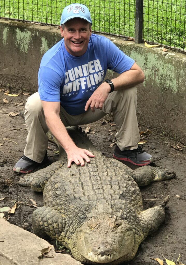 Jim with Juliet, a Nile Croc in Burundi … loves her tail rubbed!